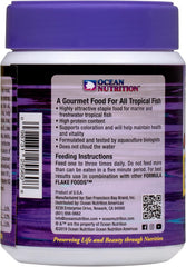 Ocean Nutrition flocons distribués dans un aquarium récifal montrant poissons se nourrissant bénéfice acceptation